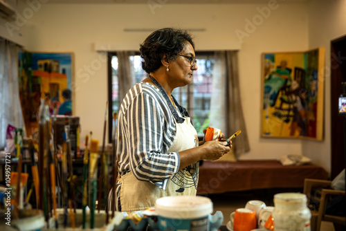 A woman creating art on her canvas. photo