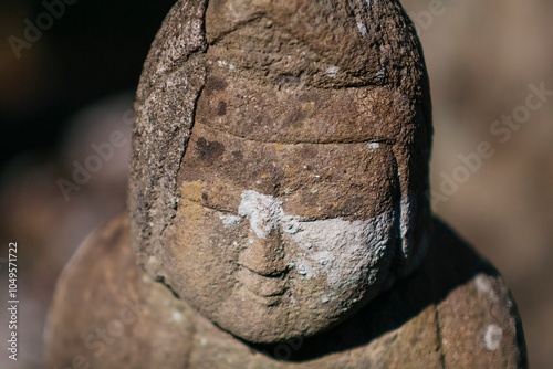 A small praying monk statue at Hase Dera Temple in Kamakura. photo