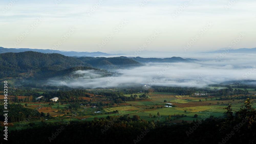 Fototapeta premium Landscape of a rural village on the mountainside in the morning with a sea of ​​fog covering it.