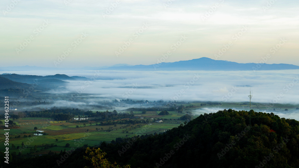 Fototapeta premium Landscape of a rural village on the mountainside in the morning with a sea of ​​fog covering it.