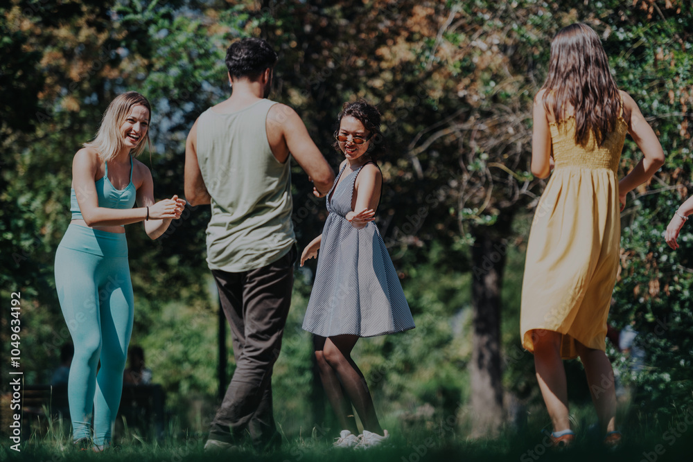 A joyful group of diverse friends having fun in a lush park, basking in the sunshine and sharing laughter while enjoying outdoor activities. A joyful group of diverse friends having fun in a lush park, basking in the sunshine and sharing laughter while enjoying outdoor activities.