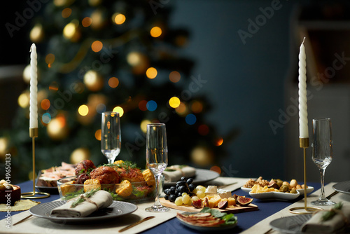 Background shot of turkey dinner with cheese and fruit platters served with side dishes at festive table decorated with candlesticks, copy space photo