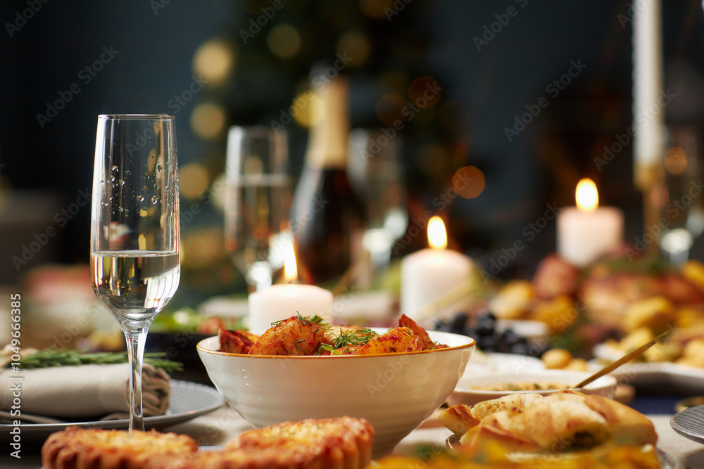 Background shot of baked potato wedges as side dish and champagne glass with sparkling drink served on festive dining table on Christmas Eve, copy space Background shot of baked potato wedges as side dish and champagne glass with sparkling drink served on festive dining table on Christmas Eve, copy space