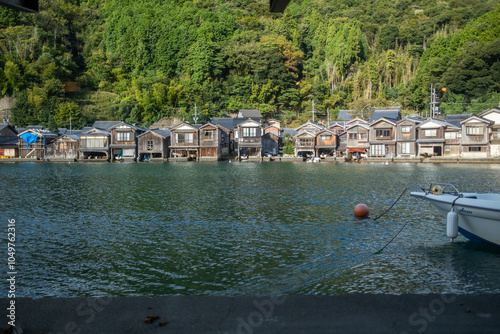Obraz na płótnie Ine Fishing Village, is famous for its unique funaya, or boat houses. These wooden buildings sit right on the water and serve as both dock and home for the fishermen w salonie