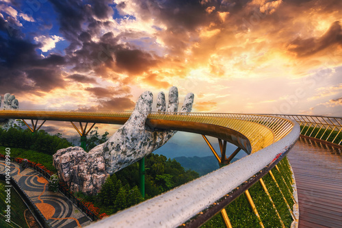 Golden Bridge or Hand of Gods bridge at Sun World Ba Na Hills amusement Park in Da Nang in Vietnam on the mountain at sunrise in summer photo