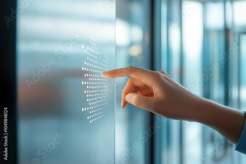 A visually impaired person touching a Braille sign on a modern office door, with blurred background. photo