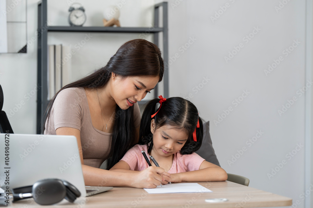 Working mother using laptop and help her daughter doing homework at home Working mother using laptop and help her daughter doing homework at home