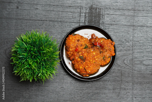 Parippuvada, also known as Rasa Vadai, is a traditional Kerala snack made from lentils, onions, and spices. These crispy, golden-brown fritters are a popular tea-time accompaniment in Indian cuisine,  photo