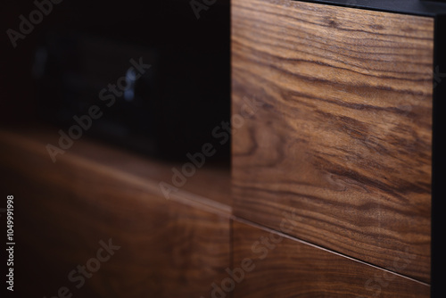 Fotografia Closeup details of modern tv stand made from walnut and powder coated steed