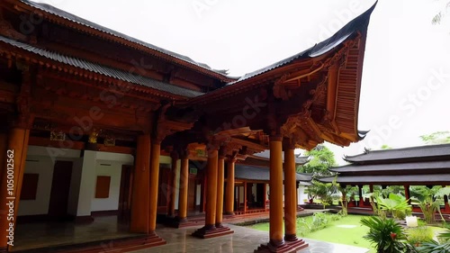 Javanese pendopo connected to other spaces for gatherings or relaxation, offering a serene atmosphere to enjoy nature. The open structure promotes harmony with the environment. photo