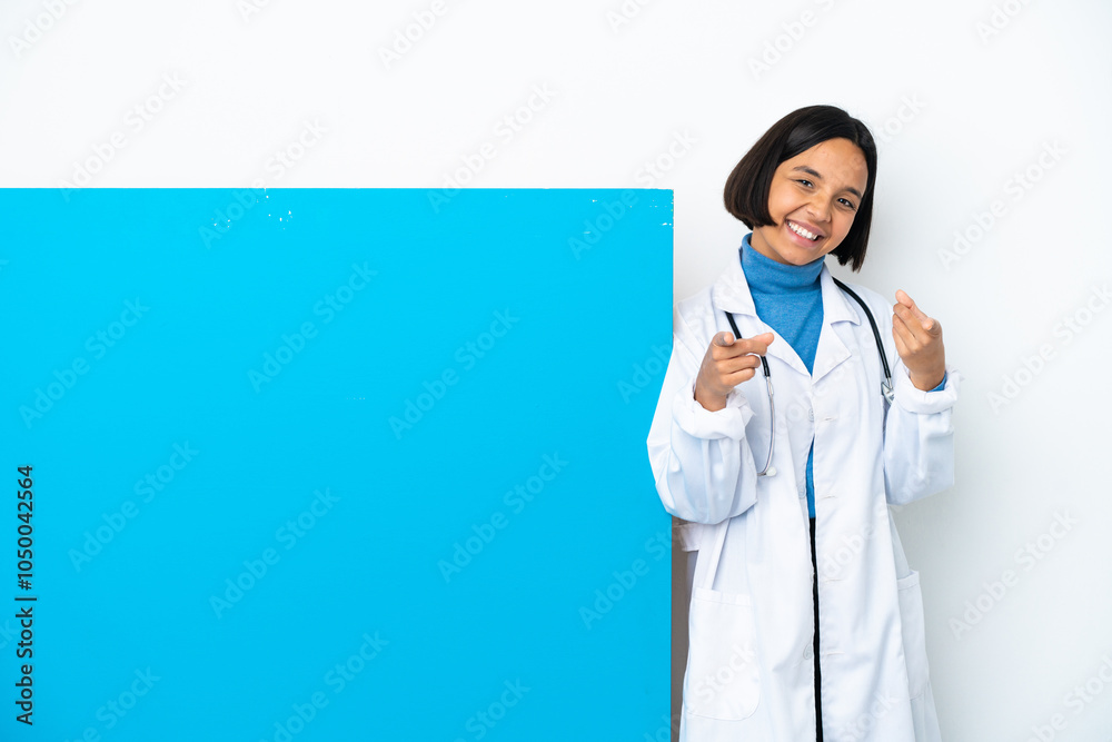 Young mixed race doctor woman with a big placard isolated on white background pointing front with happy expression Young mixed race doctor woman with a big placard isolated on white background pointing front with happy expression