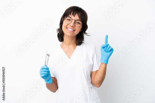 Young woman holding tools isolated on white background pointing up a great idea