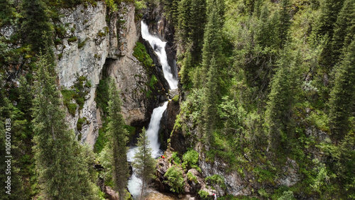 The photo shows a waterfall in the Turgen Gorge - a silk ribbon of water cascading down the mountainside