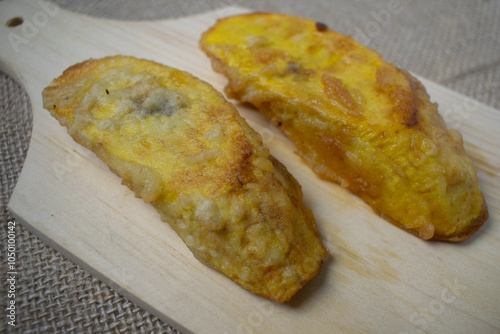 Fried bananas on a wooden cutting board photo