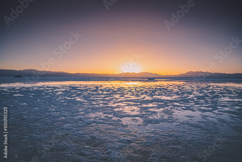 The magnificent scenery of Chaka Salt Lake with a setting sun, Qinghai, China photo