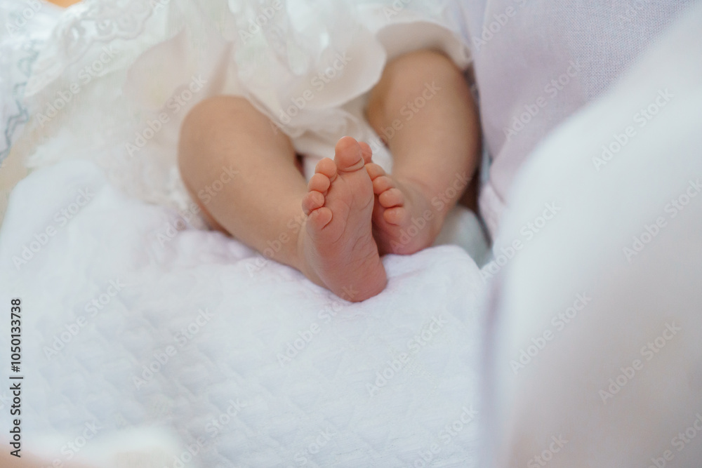 Tender Newborn Feet Resting on a Soft White Blanket Tender Newborn Feet Resting on a Soft White Blanket