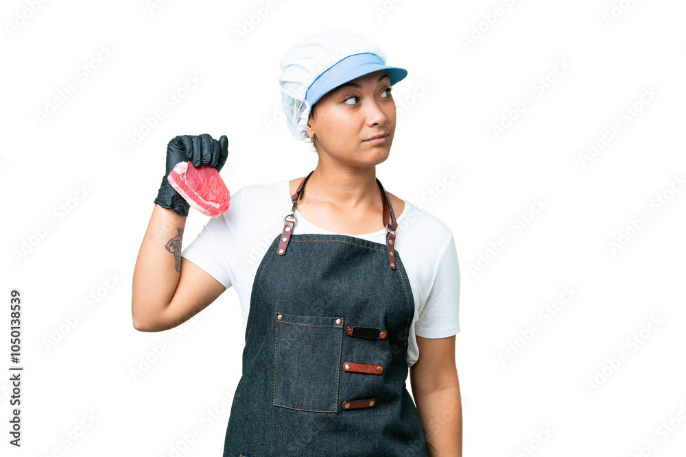 Butcher woman wearing an apron and serving fresh cut meat over isolated chroma key background looking to the side Butcher woman wearing an apron and serving fresh cut meat over isolated chroma key background looking to the side