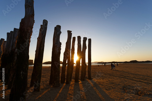 An idyllic beach scene featuring a picturesque view of a golden sunset in Saint-Malo .