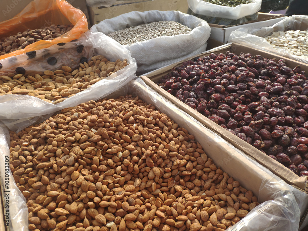 Obraz premium Different nuts on wooden counter for sale at market in Georgia