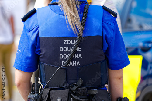 Photos Swiss Zürich Kloten Airport with rear view of back of female customs officer on a sunny late summer day