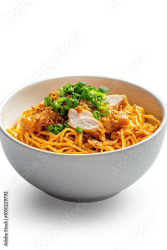 Bowl of Khao Soi with chicken and crispy noodles, isolated for cultural richness