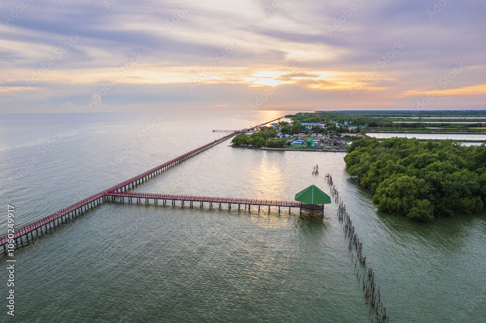 Fototapeta premium Colorful sunset on the sea at Red Bridge, Samut Sakhon province, Thailand.
