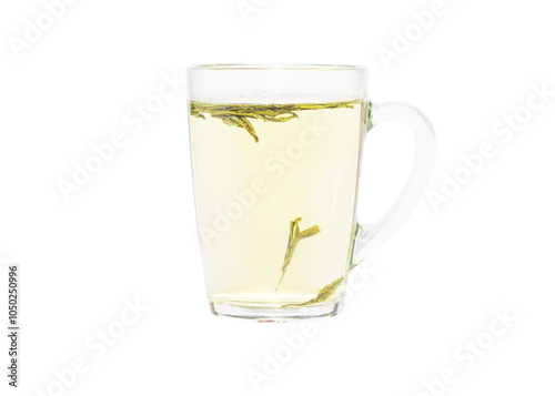 Water has just been added to a transparent cup with green tea leaves. Dragon Well green tea (Longjing tea). Isolated on a white background. photo