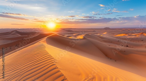 Wallpaper Mural A dramatic view of the vast sand dunes and sweeping desert landscape of the Sahara with the sun setting over the horizon, desert setting with warm, golden hues Torontodigital.ca