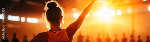 Person celebrating victory in a lively sports event with dramatic lighting.