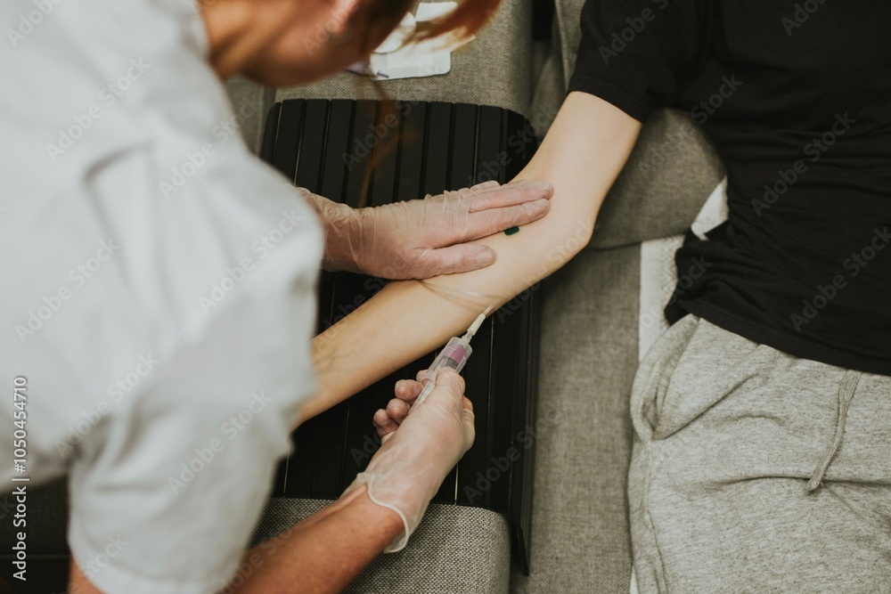 Obraz premium a nurse in gloves takes blood from a vein for analysis using a needle and a vacutainer
