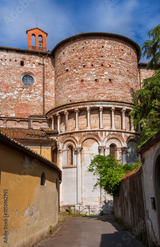 Lucca beautiful medieval historical center alley with Church of Santa Maria Forisportam apse photo