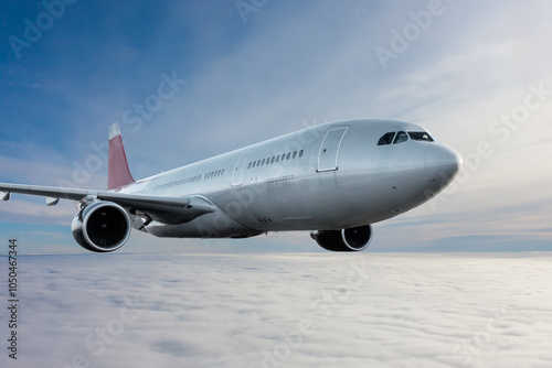 Wide body passenger jet plane flies in the air above the clouds photo