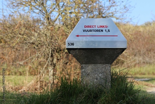 Low road sign in the Netherlands (for bicyles). This sign points towards the lighthouse (on the island Schiermonnikoog). photo