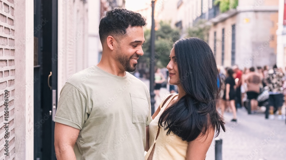 Happy couple looking at each other in city Happy couple looking at each other in city