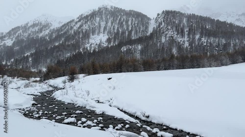 landscape with snow; mountains in the background; camera mouving from the left to the right photo