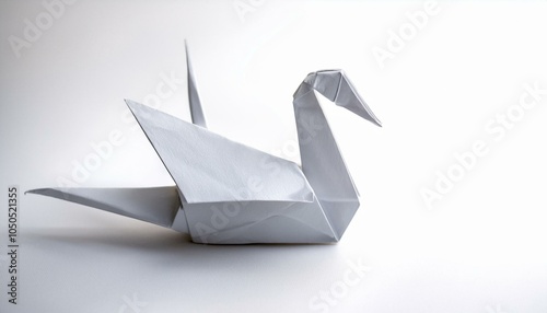 White origami swan on white background