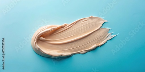 Creamy cosmetic texture smudged in medium shot on blue background