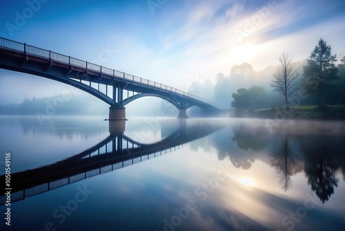 Mysterious bridge disappearing into mist over tranquil water reflection