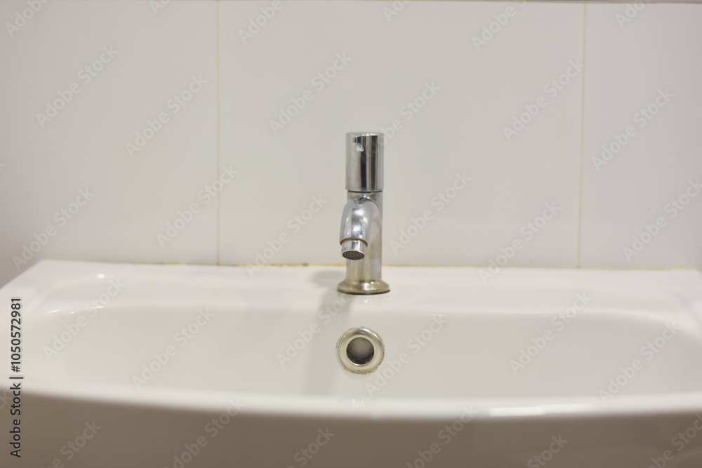 Fototapeta premium Stainless steel faucet in the bathroom