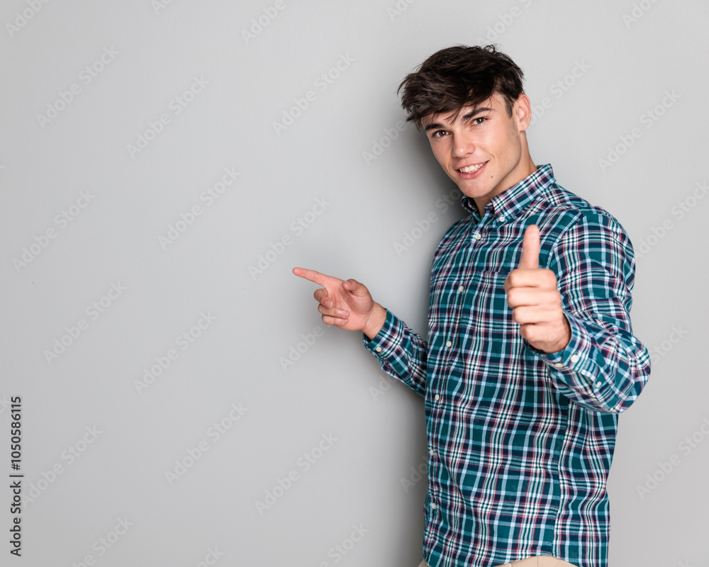 confident young man in plaid shirt making thumbs up gesture confident young man in plaid shirt making thumbs up gesture