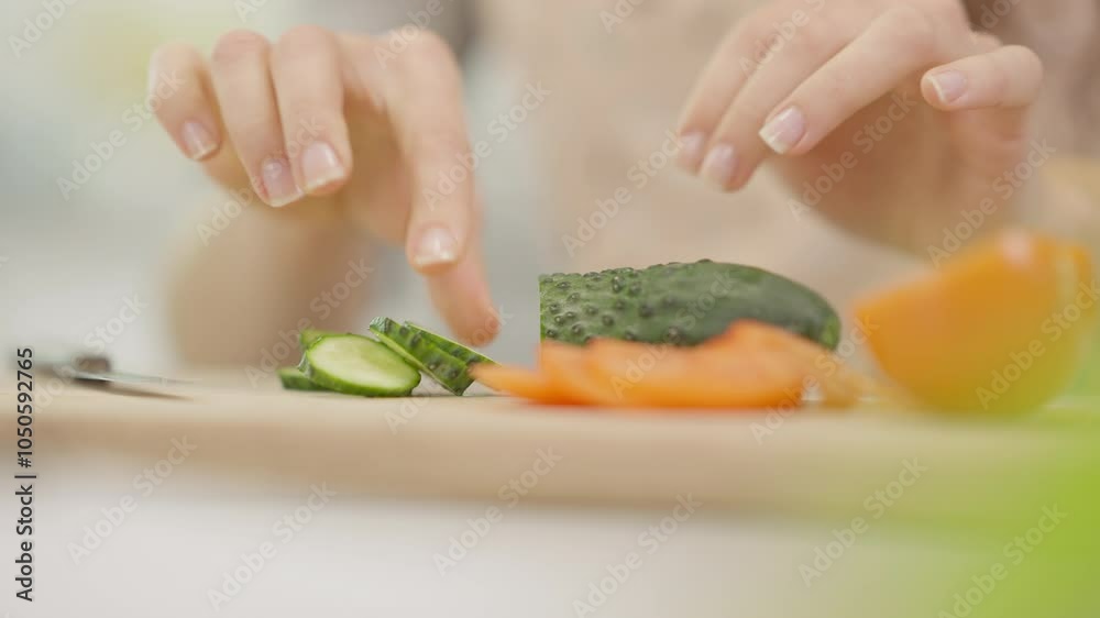 A closeup image of a hand expertly slicing a fresh cucumber, highlighting vibrant vegetables for a healthy dish A closeup image of a hand expertly slicing a fresh cucumber, highlighting vibrant vegetables for a healthy dish