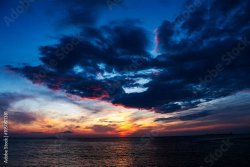 Sunset over the ocean with stormy clouds