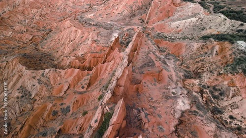 Skazka fairytale canyon, Kyrgyzstan. Aerial drone view of beautiful sharp rugged rock formations. Cinematic travelling shot panning down in famous mystical landmark adventure travel destination.