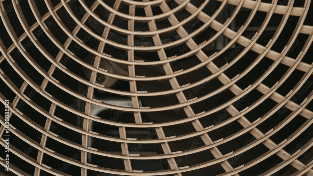 Close-up of a circular air vent with a grid pattern, showcasing its intricate design and texture. Close-up of a circular air vent with a grid pattern, showcasing its intricate design and texture.