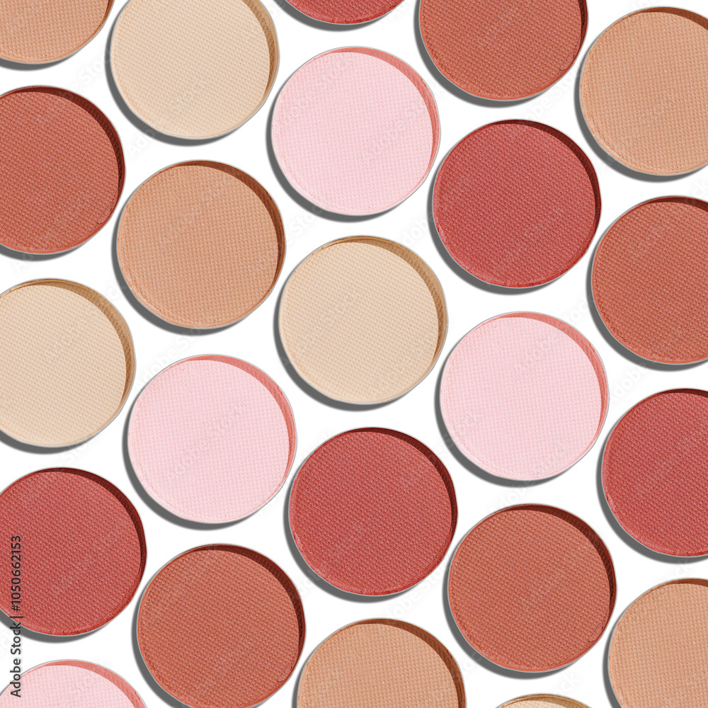 Fototapeta premium Swatches eyeshadow refills as minimal geometric pattern on white. Pastel matte pans brown beige nude shades with sun shadows, detailed texture, cosmetic, beauty concept makeup, top view layout