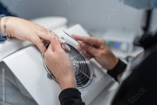 Wallpaper Mural Professional woman manicurist doing manicure and filing nail with nail file in beauty salon. Girl doing hand care Torontodigital.ca