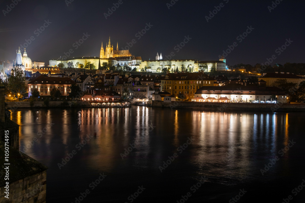 Prag city center at night, photographed by Vltava River with the fortress and Charles bridge Prag city center at night, photographed by Vltava River with the fortress and Charles bridge
