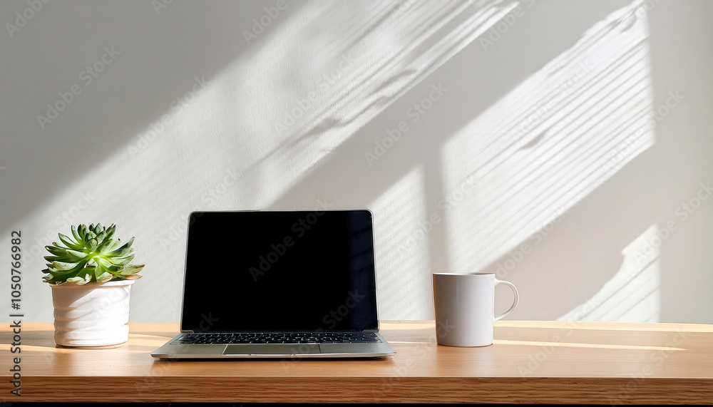 A clean, modern desk setup featuring a sleek laptop, a white coffee cup, and a small potted plant, creating a stylish and inviting workspace. A clean, modern desk setup featuring a sleek laptop, a white coffee cup, and a small potted plant, creating a stylish and inviting workspace.