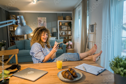 woman caucasian play video games on smartphone mobile phone at home