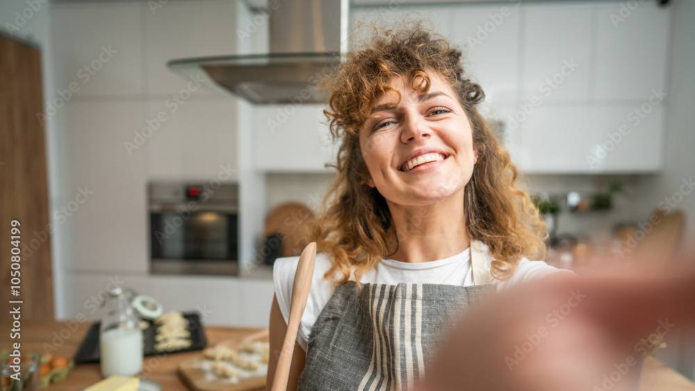 One happy young adult caucasian woman wear apron in the kitchen smile One happy young adult caucasian woman wear apron in the kitchen smile